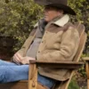 yellowstone john dutton are sitting on chair with beige leather jacket